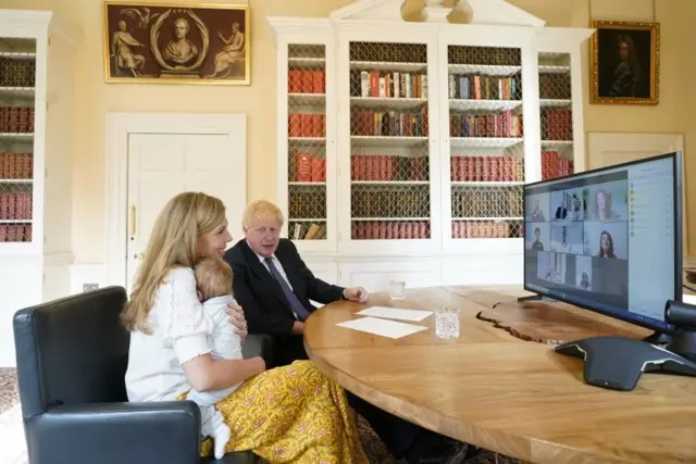 Boris Johnson and Carrie NHS Call.The Prime Minister Boris Johnson and his partner Carrie Symonds with their baby son Wilfred in the study of No10 Downing Street speaking via zoom to the midwifes that helped deliver their son at the UCLH