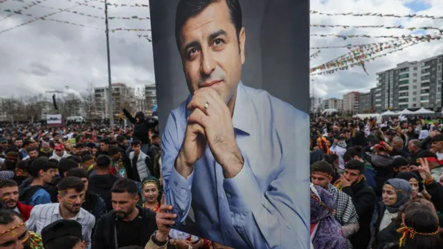 21 Mart 2025 tarihinde Diyarbakır'da düzenlenen Nevruz kutlamaları sırasında, yoğun bir kalabalığın arasında bir kişi Selahattin Demirtaş’ın portresini elinde tutuyor.