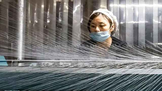 A woman working in a textile factory in Nantong in China's eastern Jiangsu province