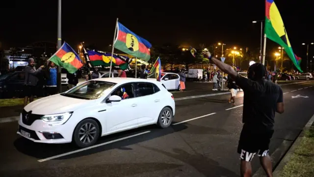 Kanak independence supporters wave flags of the Socialist Kanak National Liberation Front (FLNKS) after the referendum on independence in NoumÃ©a on 4 October 2020