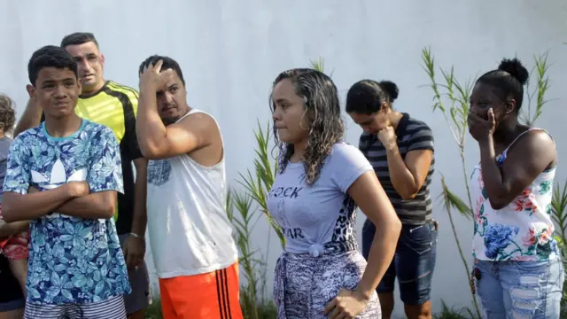 People wait for information in front of the training center of Rio"s soccer club Flamengo, after a deadly fire in Rio de Janeiro, Brazil February 8, 2019