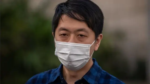 Former pro-democracy lawmaker Ted Hui Chi-fung, (R), stands outside the Western Police Station in Hong Kong, China, 18 November 2020