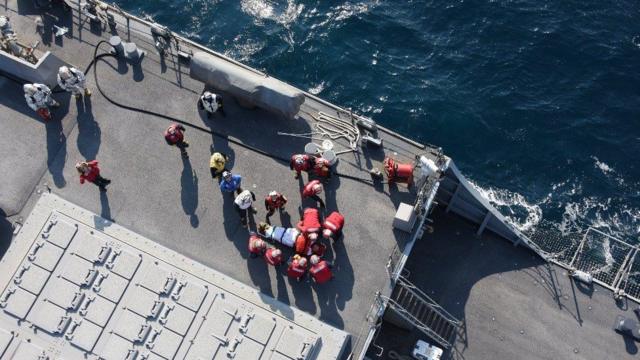 A handout photo made available by Japan"s Defense Ministry, showing US military personnel preparing to transfer an injured person on board the USS Fitzgerald