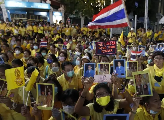 Thai royalists wearing yellow attire hold photographs of the King and royal family during a pro-monarch demonstration outside the Grand Palace in Bangkok, Thailand, 01 November 2020.
