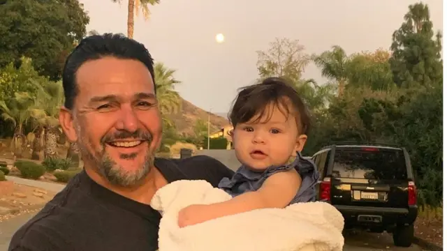 Emmanuel Cafferty with one of his grandchildren in a family picture