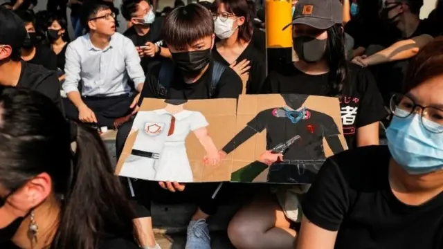 Students at Tsuen Wan Public Ho Chuen Yiu Memorial College show solidarity with the shot protester