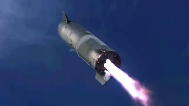 A SpaceX rocket seen from below as it comes in to land on Earth
