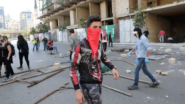 ናብራ ዝኸበዶም መንእሰያት ሊባኖስ፡ መሸፈኒ ገጽ ማስክ ጌሮም ንተቓውሞ ናብ ጎደናታት ቤይሩት ኣብ ዝወጹሉ እዋን፡ ሚያዚያ 23