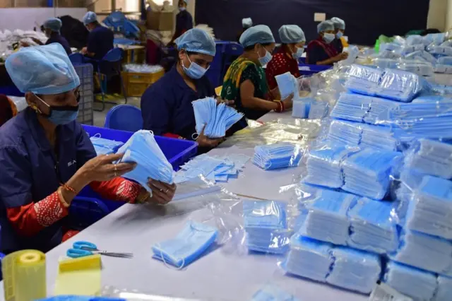 कोविड की नई लहर की आशंका के मद्देनज़र कोविड महामारी से जुड़े मास्क जैसे उत्पादों का उत्पादन भी बढ़ाया जा रहा है. ये तस्वीर अहमदाबाद की है.