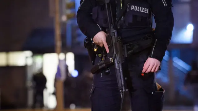 Police officers attend at the scene of a shooting that has left at least six people dead and four wounded in Alsterdorf district, on March 9, 2023 in Hamburg, Germany.