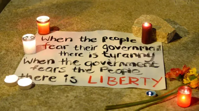 A message reading "when the people fear their government, there is tyranny, when the government fears the people, there is liberty (freedom" is seen on the pavement as thousands of people gather for a candlelight vigil in Sliema, on October 16, 2017