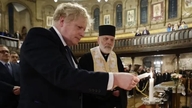 UK Prime Minister Boris Johnson lights a candle at the Ukrainian Catholic Cathedral in London