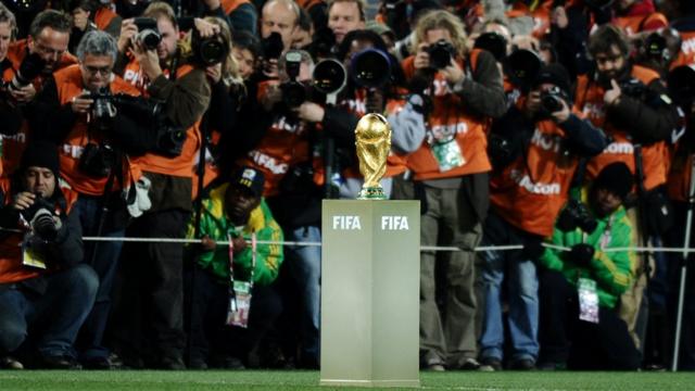 Photographers take pictures of the World Cup trophy prior to the start of the 2010 World Cup final football match Netherlands versus Spain on July 11, 2010 at Soccer City stadium in Soweto, a suburb of Johannesburg