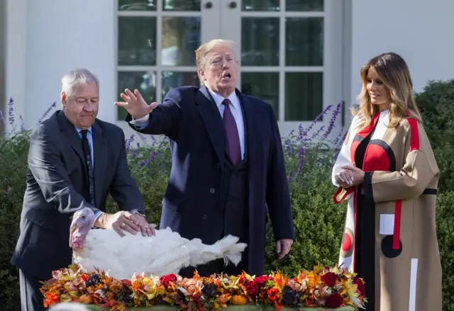 US President Donald Trump, First Lady Melania Trump and Jeff Sveen participate in the pardoning of the National Thanksgiving Turkey
