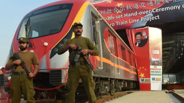 Pakistani policemen stand guard during the unveiling ceremony of the first set of carriages of Lahore Orange Line MetroTrain in Lahore on October 8, 2017.