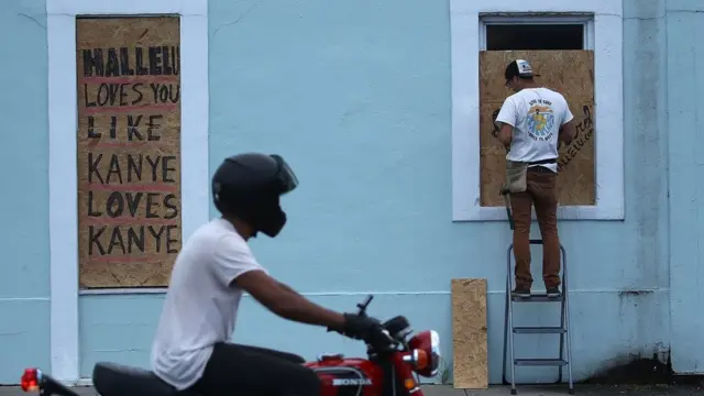 Windows are boarded up as local shops prepare for the arrival of Hurricane Florence on September 11, 2018 in Wrightsville Beach, United States