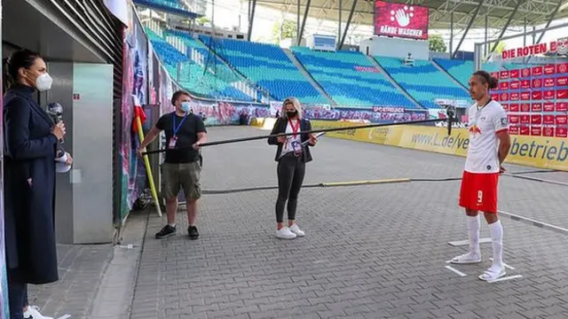 RB Leipzig striker Yussuf Poulsen is interviewed from a safe distance
