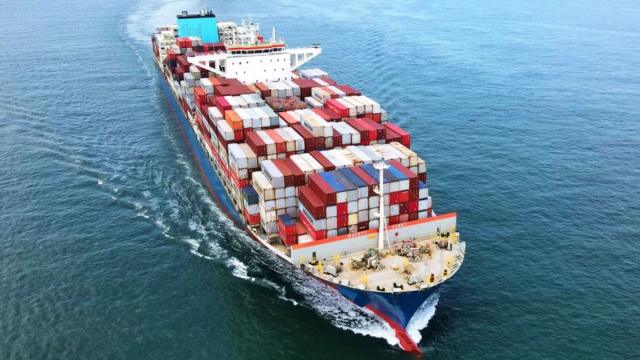 A container ship navigates the Jiaozhou Bay in Qingdao, East China's Shandong Province