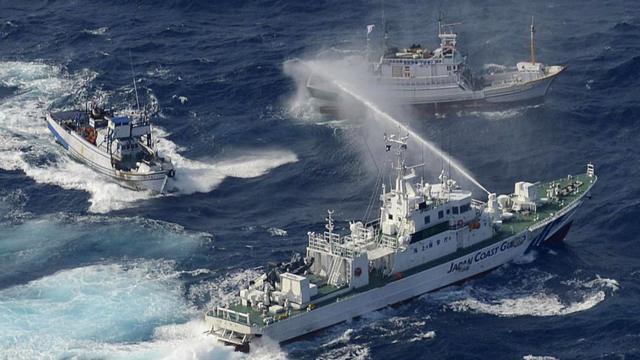 A Japan Coast Guard vessel (lower) sprays water against Taiwanese fishing boats, in the East China Sea near the Senkaku islands as known in Japanese or Diaoyu Islands in Chinese on September 25, 2012.