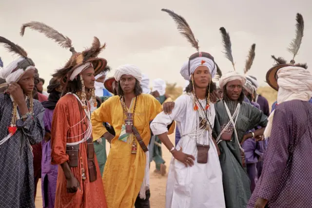 A group of Wodaabe men rest after dancing during the Cure Salee, in Ingall, northern Niger, on 18 September.