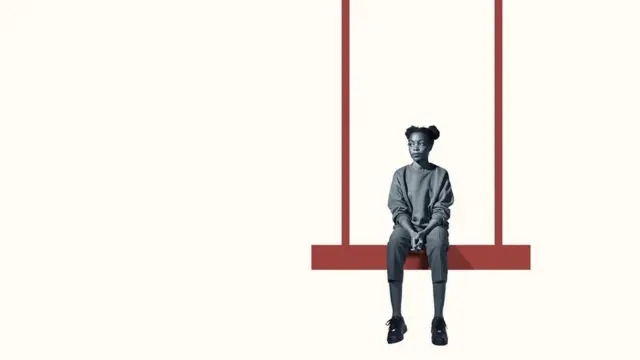 A young woman sitting on a swing, looking into empty space