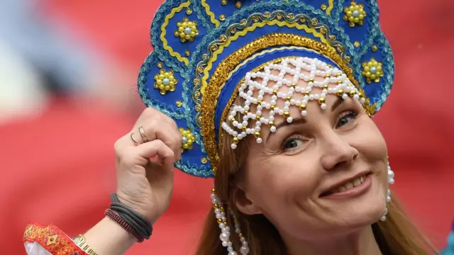 A female Russian football supporter wearing traditional headwear
