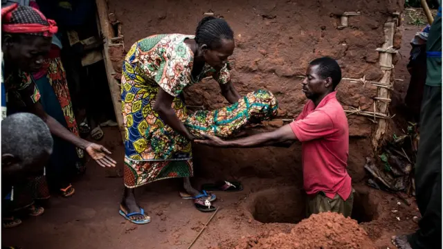 A child killed by malaria is being buried