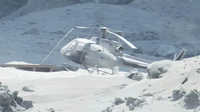 Helicopter covered in ash on White Island, 9 December