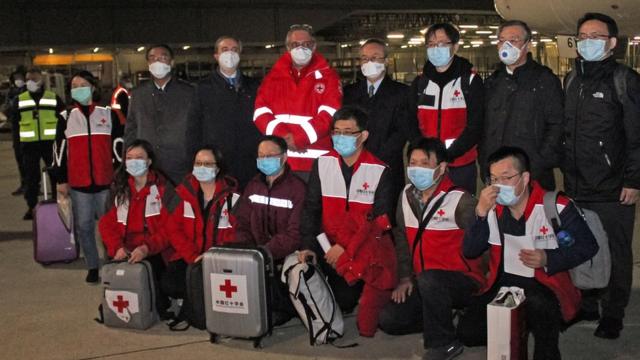Chinese medics posing for a group photo after landing on a China Eastern flight on March 13 at Rome"s Fiumicino international airport from Shanghai, bringing medical aid to help fight the new coronavirus in Italy