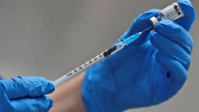 медсестра с пузырьком и шприцем