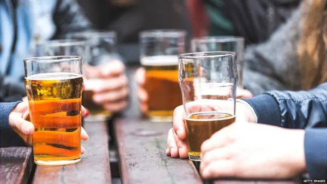 Hands holding beer glasses