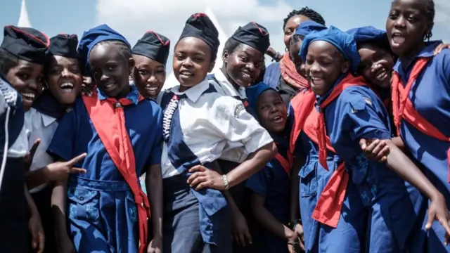 Members of Kenya Girl Guides take photos after attending ceremony of the International Women's day at Kawangware in Nairobi, Kenya, on March 8, 2018.