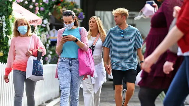 People wear face masks while shopping at Covent Garden on Sunday