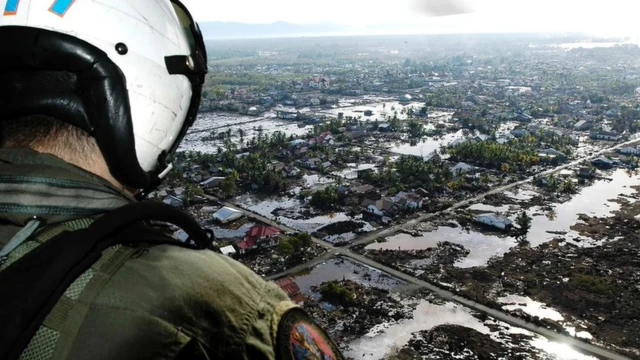 A US helicopter flies above a region hit by the 2004 tsunami in Indonesia