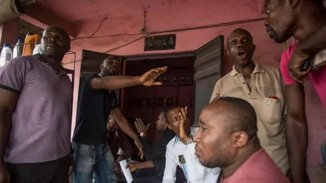 Men discussing the election in Aba, Nigeria - Thursday 14 February 2019