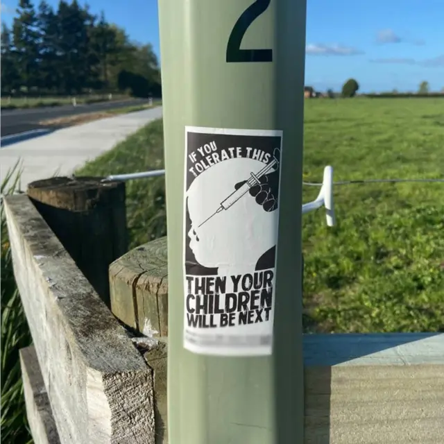 A sticker showing a child being injected and the slogan: "If you accept this then your children will be next"