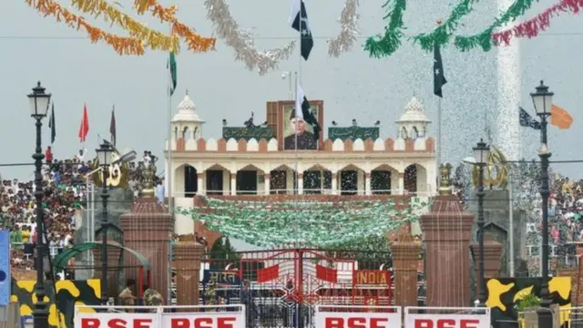 People gather as them raise Pakistan flag at Wagah, wey be land border between Pakistan and India