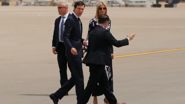 Kushner and his wife Ivanka Trump walk on the tarmac after arriving aboard Air Force One at King Khalid Airport in Riyadh