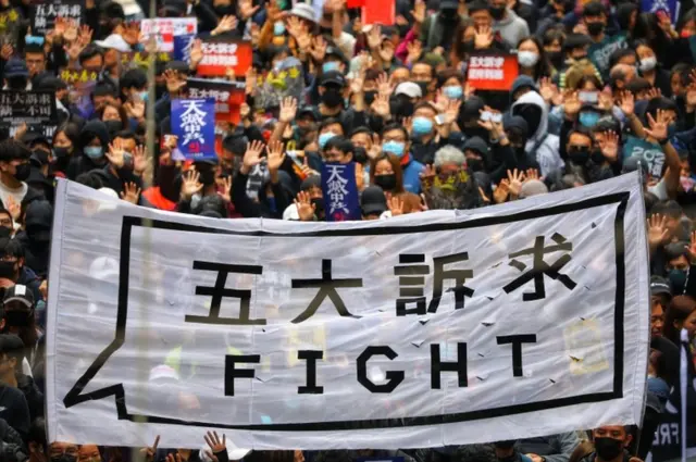 People hold a banner reading "Fight" as they take part in an anti-government rally on New Year's Day in Hong Kong