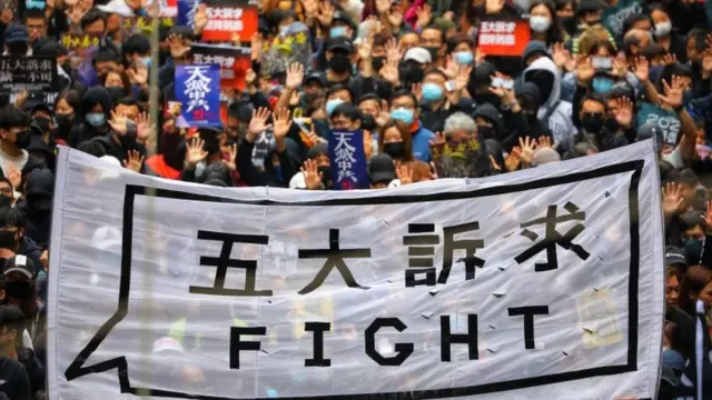 People hold a banner reading "Fight" as they take part in an anti-government rally on New Year's Day in Hong Kong