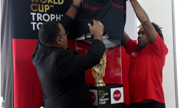 Christian Karembeu dey unveil di cup with person from Coco Cola