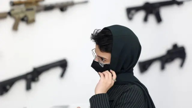 An employee works at Saudi Arabias first World Defense Show, north of the capital Riyadh, on March 6, 2022. (Photo by Fayez Nureldine / AFP) (Photo by FAYEZ NURELDINE/AFP via Getty Images)