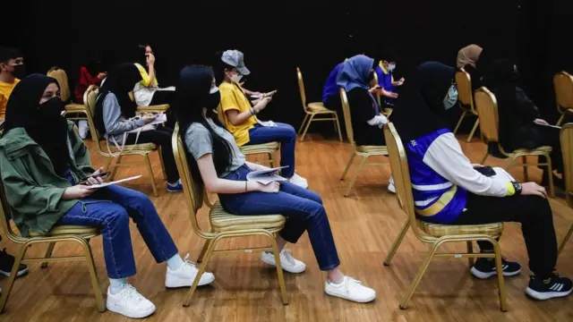 Teenagers waiting to receive a dose of Pfizer COVID-19 vaccine during a vaccination program for teenagers under 18-year-old in Shah Alam, outside Kuala Lumpur, Malaysia