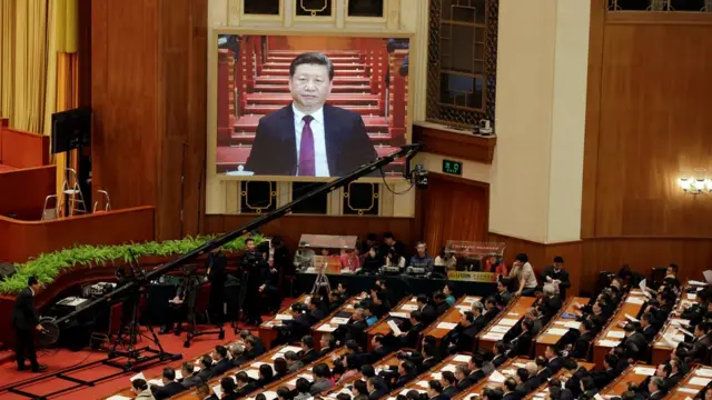 China's President Xi Jinping seen on a screen as he attends the opening session of the Chinese People's Political Consultative Conference (CPPCC) at the Great Hall of the People in Beijing, China, 3 March 2017
