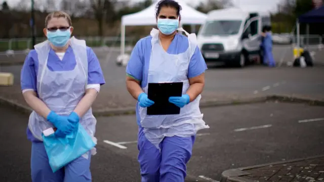 NHS nurses wait for the next patient at a drive through Coronavirus testing site