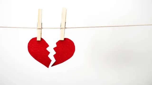 A picture of a broken heart hanging on a washing line