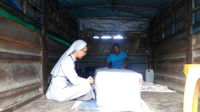 Laurentina berdoa di dalam truk yang mengantarkan jenazah.