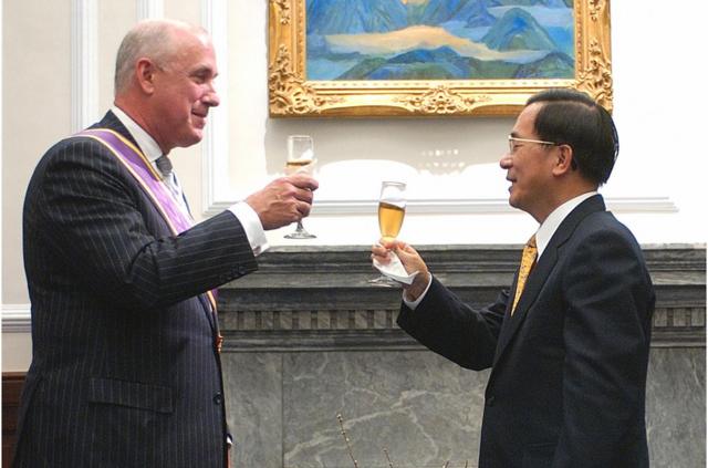 Taiwan's President Chen Shui-bian, right, toasts with American Institute in Taiwan (AIT) Director Douglas Paal during a meeting at the Presidential Palace, Monday, Jan. 23, 2006, in Taipei, Taiwan. Paal will leave the AIT, the US. de facto embassy in Taipei, after three-and-a-half years on Jan. 25 and has been awarded the Order of the Brilliant Star by President Chen. (AP Photo/Jerome Favre) (Photo credit should read JEROME FAVRE/AFP/Getty Images)