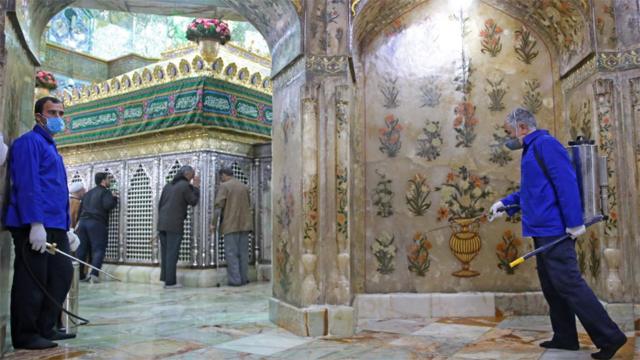 Workers disinfect the Hazrat Masumeh shrine in Qom on 25 February 2020