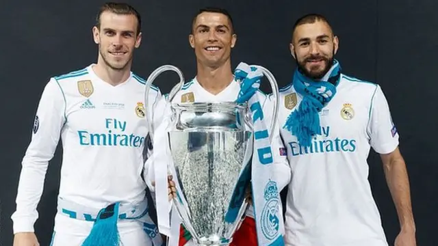 Gareth Bale, Cristiano Ronaldo and Karim Benzema pose with the 2018 Champions League trophy